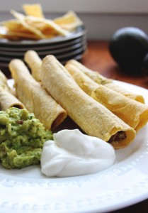 Low fat baked taquitos with Randall's Black Beans.